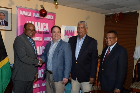 Minister of Tourism, Hon. Edmund Bartlett (left) shakes hands with Airbnb’s Public Policy Director for Central America and the Caribbean, Shawn Sullivan following the signing of a memorandum of understanding (MOU) between the Jamaica Tourist Board (JTB) and home-sharing accommodation company Airbnb. Sharing in the moment are Chairman of the JTB, John Lynch (second right); and Director of Tourism, Paul Pennicook.  The agreement, which was signed on December 13, 2016 at the Jamaica Tourist Board’s New Kingsto