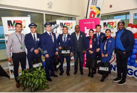 Hon. Edmund Bartlett (centre), Minister of Tourism, and Donovan White (right) Director of Tourism paused for a photo-op with Gonzalo Ramirez (left), Airport Director for North America and Caribbean at LATAM Airlines, and the LATAM Airlines crew during Sunday’s ceremony at Sangster International Airport.