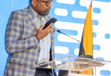Director of Tourism, Donovan White uses his cell phone to converse with the Jamaica Tourist Board’s artificial intelligence (AI) - powered Chatbot ‘Cynthia’ to demonstrate one of the many ways in which AI can be used in tourism, during his presentation on “Harnessing AI for Tourism Resilience” at the 3rd Global Tourism Resilience Conference, held recently at the Princess Grand Jamaica resort, Hanover. While welcoming the benefits of AI, Mr. White maintained that the human element of travel is irreplaceable.