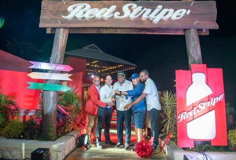 Minister of Tourism, Hon Edmund Bartlett (centre) cuts a red ribbon signalling the grand opening of the Red Stripe Experience at Rick’s Café in Negril, on Saturday, January 18, 2025. He is flanked by (from left) Head of Commerce, Red Stripe, Sean Wallace; Managing Director of Red Stripe, Daaf van Tilburg; CEO of Rick’s Cafe, Steve Ellman and Member of Parliament, Westmoreland Western, Morland Wilson.