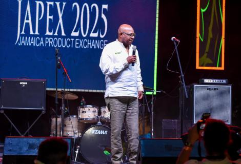 Minister Bartlett stands on stage at the JAPEX 2025 Welcome Reception held at the Harmony Beach Park on Sunday, September 21, 2025. 