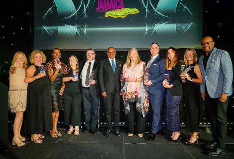 Minister of Tourism, Hon Edmund Bartlett (C) is flanked by L-R, Elizabeth Fox, Regional Director, UK, Top UK tour operators who were recognized for their contribution to selling the destination and Donovan White, Director of Tourism, at the Platinum Celebration Awards held at the Ashdown Park Hotel on Thursday October 2, 2025.