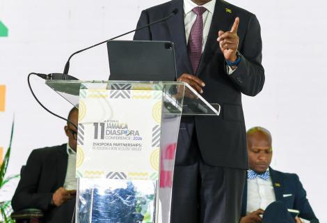 Minister of Tourism, Hon Edmund Bartlett addresses members of the Jamaican Diaspora and urges them to invest in Jamaica’s tourism industry and be its ambassadors. He was leading a panel discussion at the 11th Biennial Jamaica Diaspora Conference at the Montego Bay Convention Centre on Tuesday, June 16, 2026. Partly hidden (seated at left), is Director of Tourism, Donovan White and at right, Permanent Secretary in the Ministry of Water, Environment and Climate Change, Mr. Wayne Robertson.
