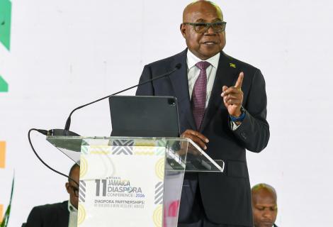 Minister of Tourism, Hon Edmund Bartlett addresses members of the Jamaican Diaspora and urges them to invest in Jamaica’s tourism industry and be its ambassadors. He was leading a panel discussion at the 11th Biennial Jamaica Diaspora Conference at the Montego Bay Convention Centre on Tuesday, June 16, 2026. Partly hidden (seated at left), is Director of Tourism, Donovan White and at right, Permanent Secretary in the Ministry of Water, Environment and Climate Change, Mr. Wayne Robertson.