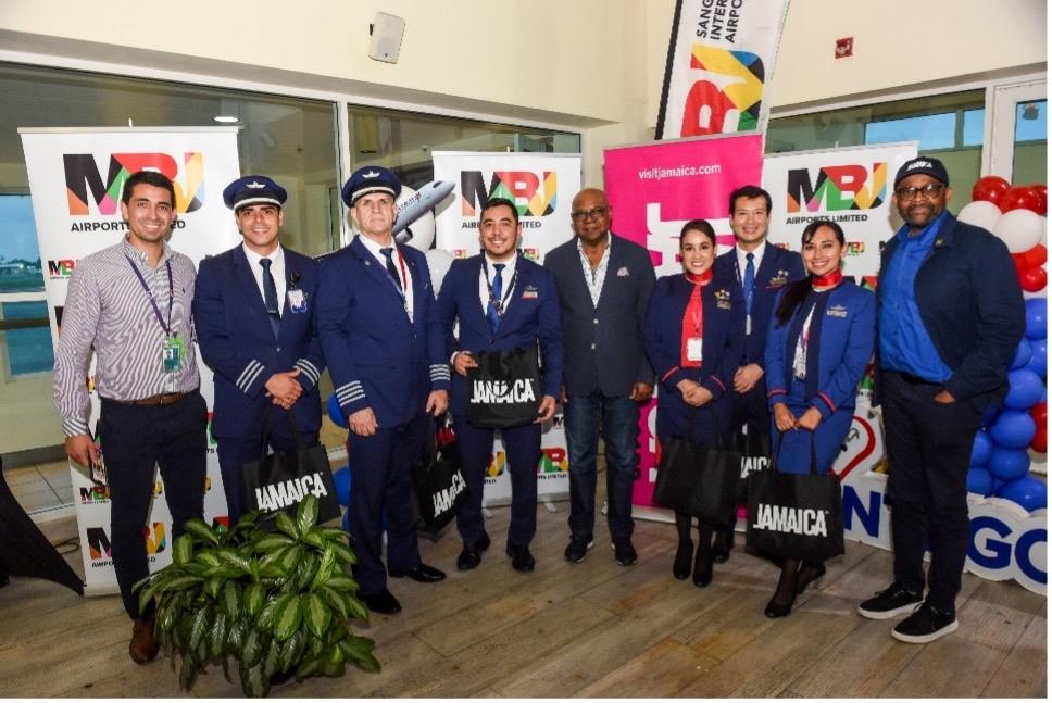 Hon. Edmund Bartlett (centre), Minister of Tourism, and Donovan White (right) Director of Tourism paused for a photo-op with Gonzalo Ramirez (left), Airport Director for North America and Caribbean at LATAM Airlines, and the LATAM Airlines crew during Sunday’s ceremony at Sangster International Airport.