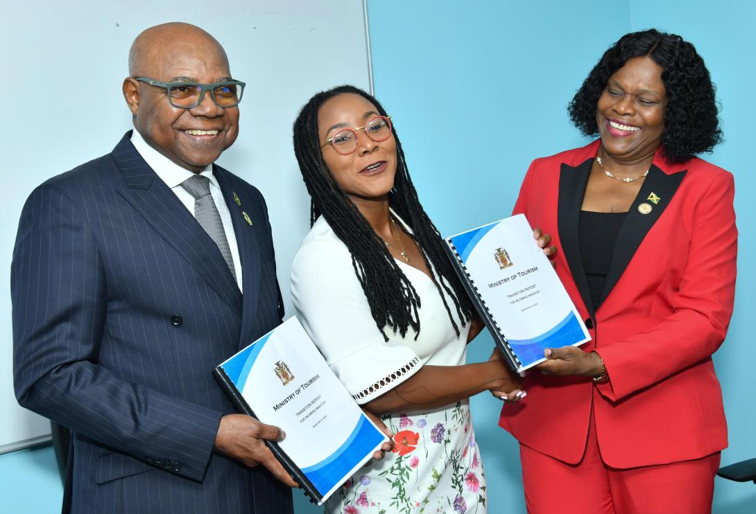 Minister of Tourism, Hon. Edmund Bartlett (left), newly minted Minister of State in the Ministry of Tourism, Hon. Tova Hamilton (centre) and Permanent Secretary in the Ministry of Tourism, Jennifer Griffith share a light moment as PS Griffith presented both ministers with a Transition Report.