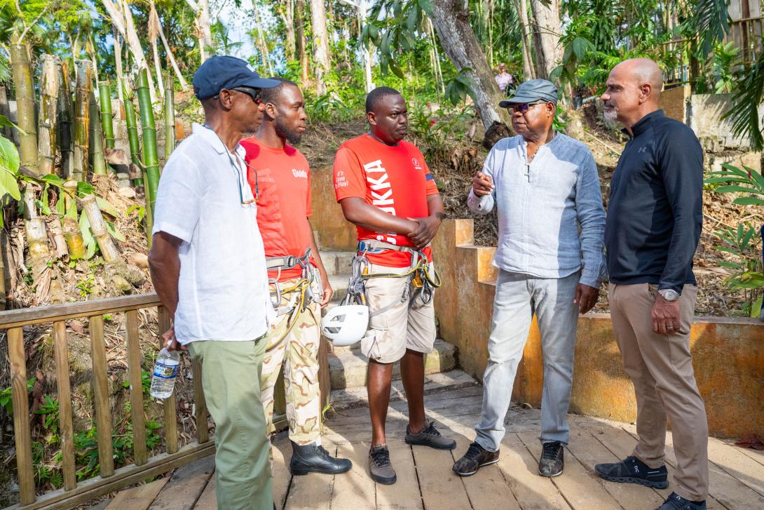Hon. Edmund Bartlett (second right), discusses the phased reopening of the tourism sector with two team members of Chukka Caribbean Adventures (second left and centre) during a stop at Dunn’s River Falls, which formed part of the Tourism Recovery Tour of Ocho Rios on Thursday, November 20, 2025. They are joined by President of the JHTA, Christopher Jarrett (left), and Chairman of the Tourism Recovery Task Force and Executive Deputy Chairman of Chukka Caribbean Adventures, John Byles. 