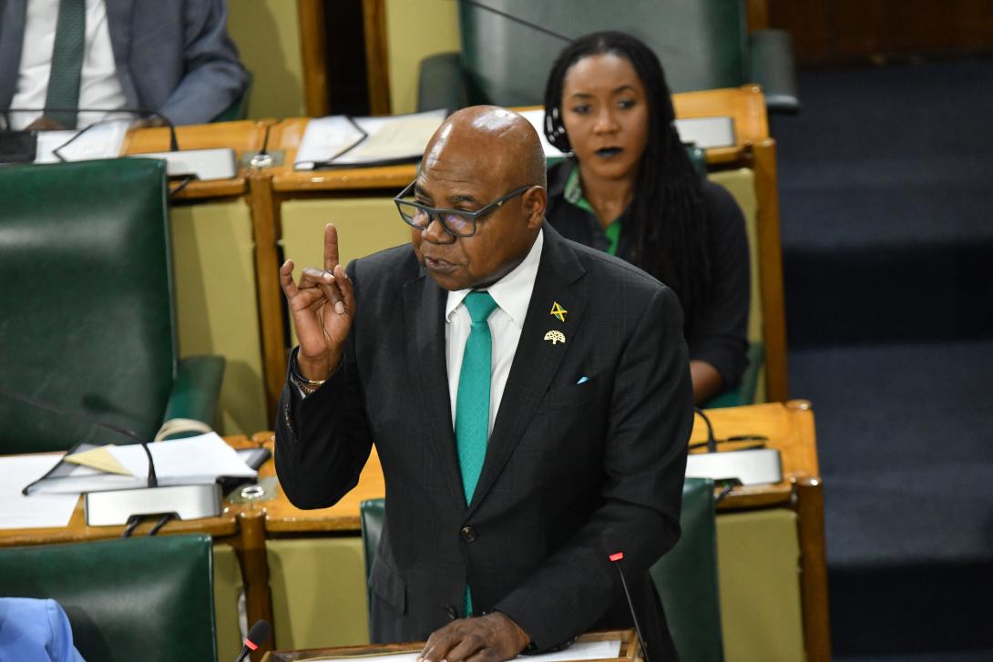 Minister of Tourism, Hon. Edmund Bartlett (foreground) delivers his 2026 Sectoral Debate Presentation in Gordon House on Tuesday, June 23, 2026, as Minister of State, Hon. Tova Hamilton looks on and listens attentively. 
